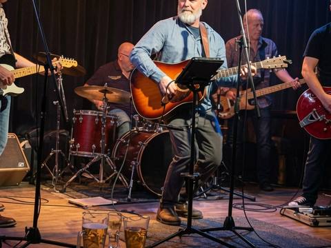 The Threads performing at a dark venue with drum kit and Gretsch guitar